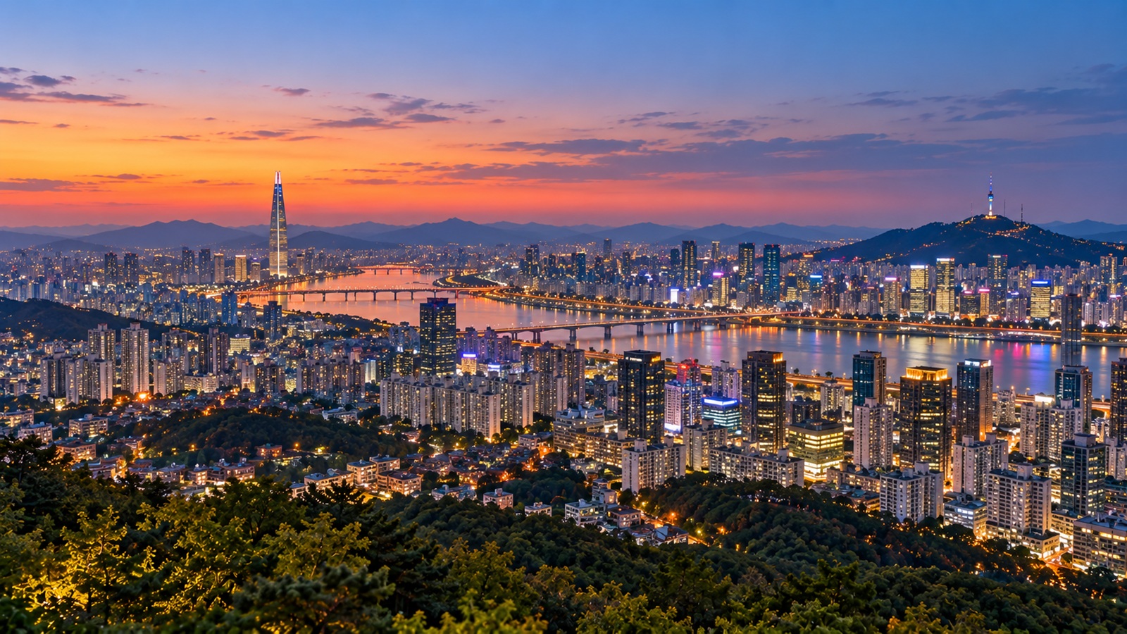 Panoramic Seoul skyline at blue hour viewed from an elevated Namsan viewpoint.